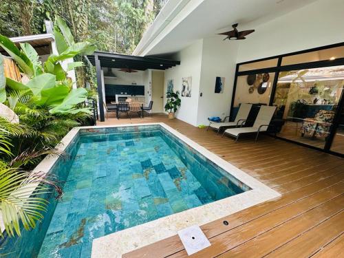 a swimming pool in the middle of a house at Casa Coral Azul in Cahuita