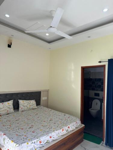 a bedroom with a bed and a ceiling fan at Spacious Villa in Dehradun in Dehradun