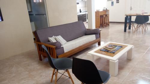 a living room with a couch and a table at Los Cerezos de Ema in Puerto Iguazú