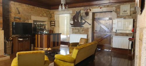 a living room with two chairs and a television at Casa do Riacho - Douro in Armamar