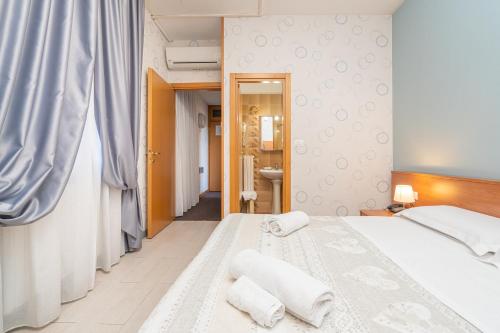 Postel nebo postele na pokoji v ubytování Hotel Donatello