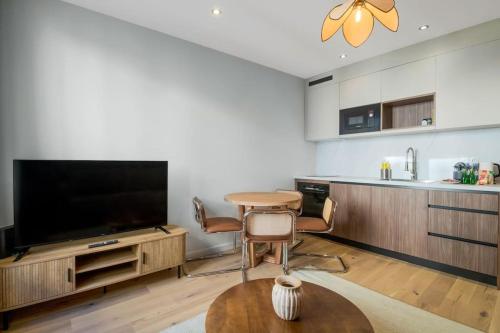 un salon avec une télévision et une table dans l'établissement 22.Appart 4Pers#1 Bedroom#Père Lachaise #Nation, à Paris