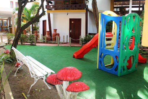 a playground with a slide and some mushrooms at Casa Blanca Park Hotel in Porto Seguro