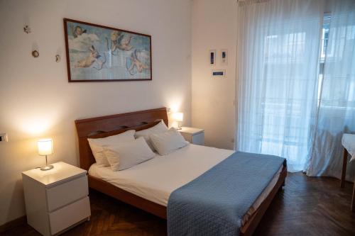 a bedroom with a large bed with a blue blanket at Discover Sustainable Bliss: 2-BR Apartment in Rome in Rome