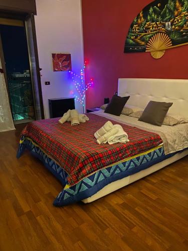 a bedroom with a bed with a blanket and a christmas tree at Lady Nisida in Naples