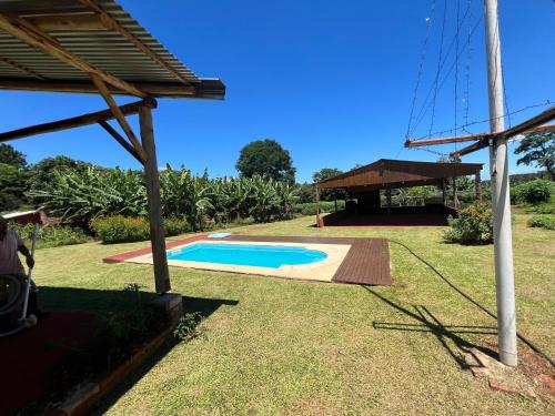 a backyard with a swimming pool and a pavilion at Casona Rural Km 1469 in Puerto Rico