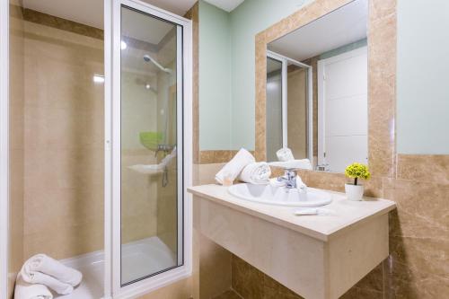 a bathroom with a sink and a shower at Love Sun Beach Apartment in Portimão