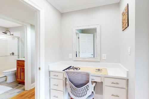 a white bathroom with a sink and a mirror at Lanai Village #181 in Diamondhead