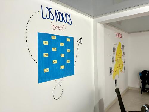 a room with a wall with a blue sign on it at Los Nonos Hostel in Guadalupe