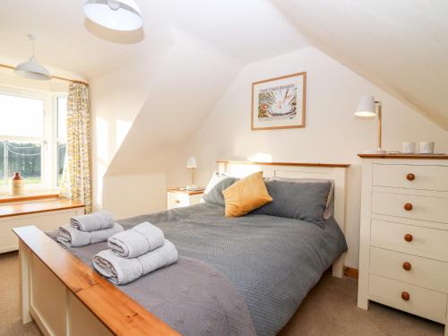 a bedroom with a bed with towels on it at Wynford Holiday Cottage in Aberdeen