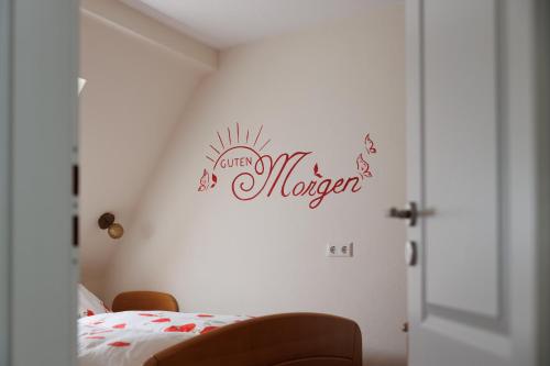 a bedroom with a bed with a sign on the wall at Winneburger Hof in Ernst