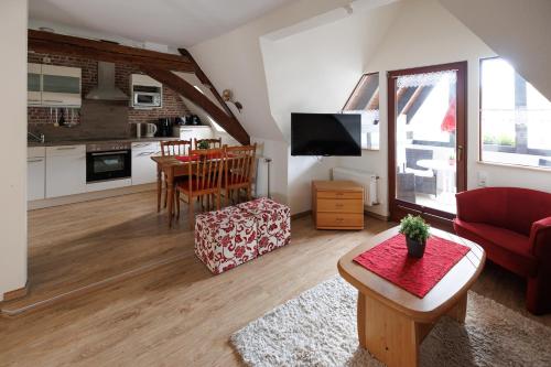 a living room with a red couch and a table at Winneburger Hof in Ernst