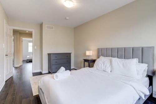a bedroom with a large white bed with white pillows at Hamilton 3BR Gem - Comfort Stay, City and Nature Mix in Hamilton