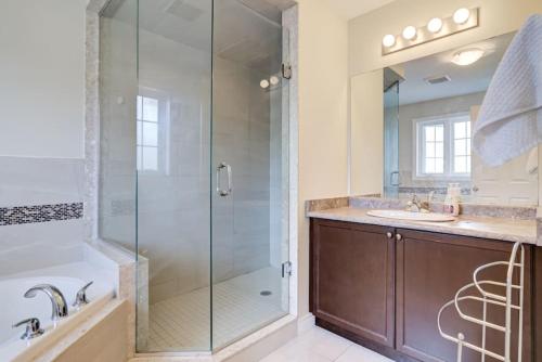 a bathroom with a glass shower and a sink at Hamilton 3BR Gem - Comfort Stay, City and Nature Mix in Hamilton