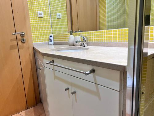 a bathroom with a sink and a mirror at Armação de Pêra Ocean Terrace With Pool by Homing in Armação de Pêra