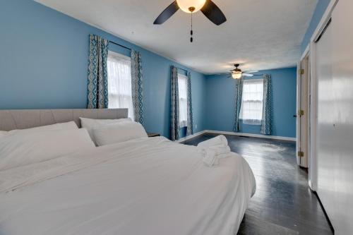 a bedroom with blue walls and a large white bed at Charming State College Home - 4 Mi to PSU! in State College