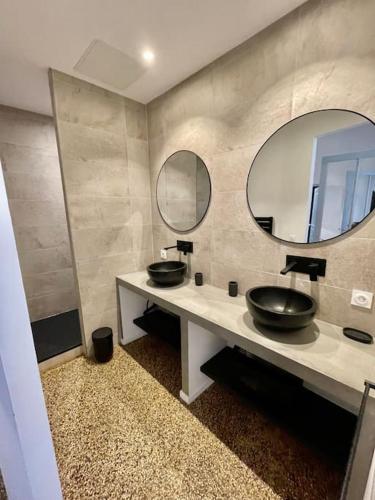 une salle de bain avec deux lavabos et deux miroirs dans l'établissement Centre historique Vintage et Moderne, Clim AC, à Montpellier