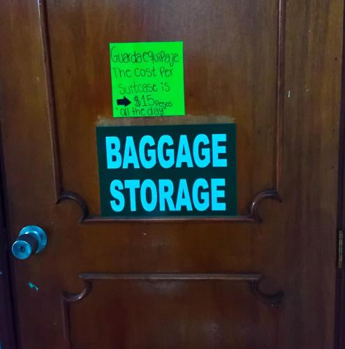 a sign on a door that reads baggage storage at Posada Nacha`n - Ka`an in Palenque