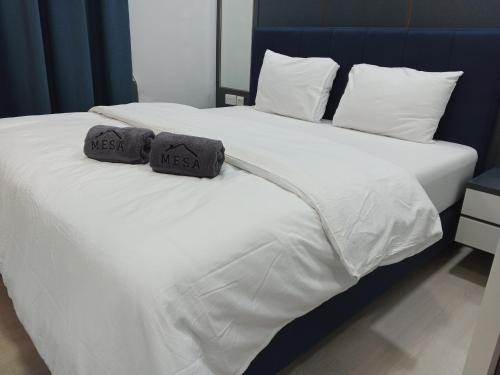 a bedroom with two beds with white sheets and pillows at Formosa Spacious Apartments with Netflix & Pick Up Service by MESA in Nagoya
