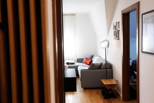 a living room with a couch and a table at UrbanKop Vidik Residence in Kopaonik