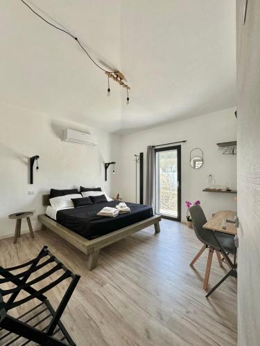 a bedroom with a bed and a table and chairs at Civico36 in Ilbono
