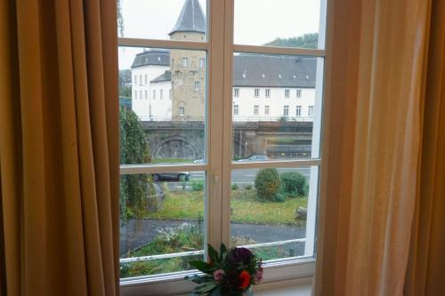 a window with a view of a city at Hotel Bucheneck in Linz am Rhein