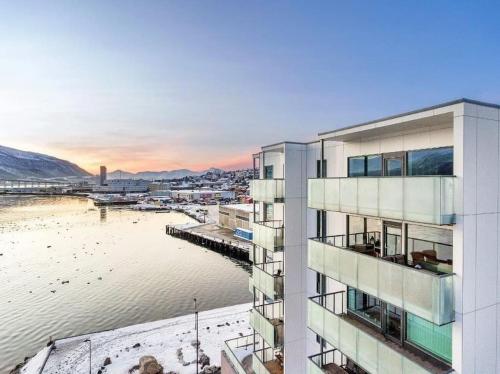 a building with a view of a body of water at Beautiful home with seaview in Tromsø
