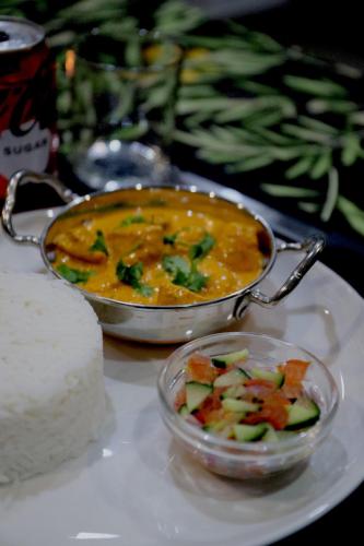 a bowl of soup and a bowl of vegetables on a table at The Raz in Harrismith