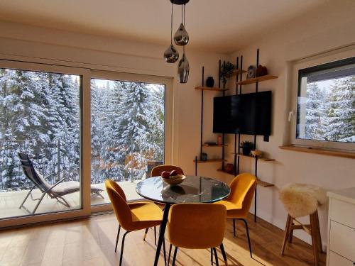 a dining room with a table and chairs and a window at GO Jahorina by Olympic Gardens in Jahorina