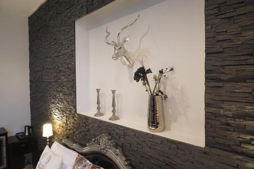 a shelf above a fireplace with vases on it at Hotel Bucheneck in Linz am Rhein
