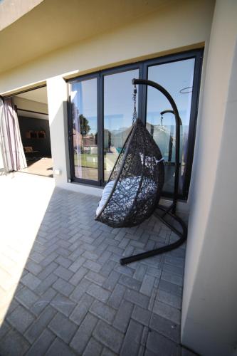 a hammock hanging on the side of a building at The Raz in Harrismith