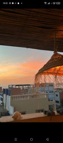 a view of a building with a straw umbrella at rihhana house in Agadir
