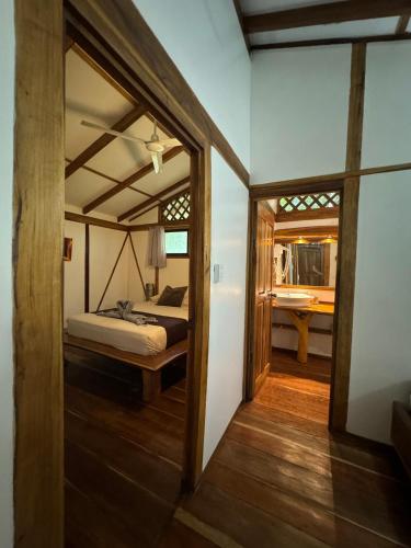 a view of a bedroom with a bed and a bathroom at Passion Fruit Lodge in Cahuita