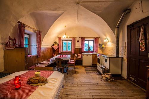 a large room with a table and a kitchen at Ferienbauernhof Elmaugut in Mühlbach am Hochkönig