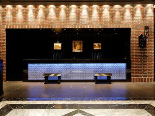 two benches in a room with paintings on the wall at Hotel Monterey Kyoto in Kyoto