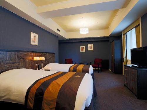 Postel nebo postele na pokoji v ubytování Hotel Monterey Kyoto