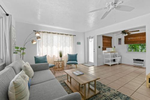 a living room with a couch and a table at Sunshine shores boutique apartments in Palm Beach Shores