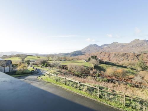 a view of a road with mountains in the background at Y Tylwyth in Blaenau-Ffestiniog