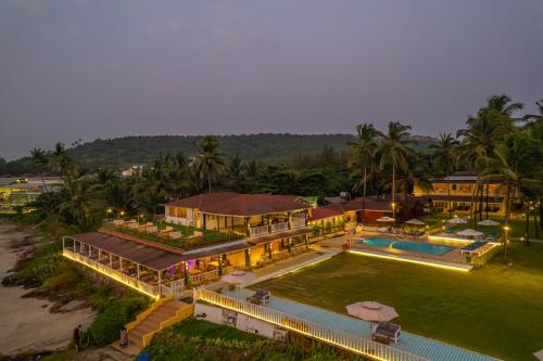 an aerial view of a house with a swimming pool at La Cabana Beach & Spa, By Ashvem Beach in Mandrem