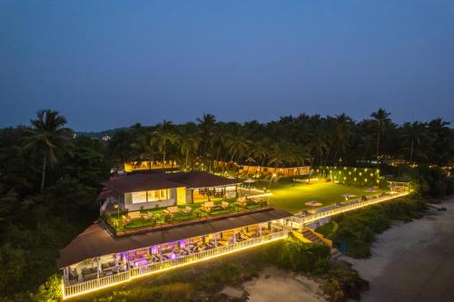 an aerial view of a resort at night at La Cabana Beach & Spa, By Ashvem Beach in Mandrem