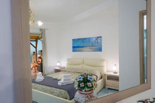 a bedroom with a bed and a mirror at Casa Marianna in Praiano