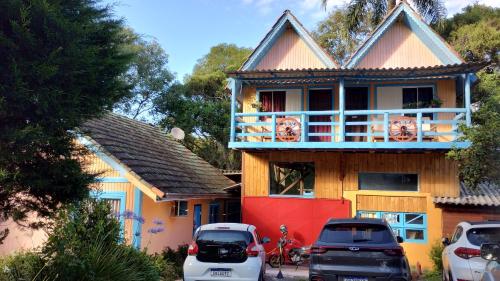 a house with cars parked in front of it at Residencial Saldanha in Gramado