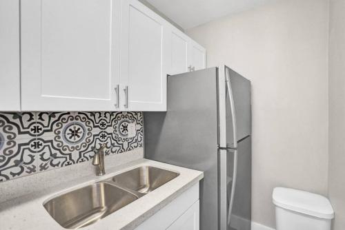 La cuisine est équipée d'un évier et d'un réfrigérateur. dans l'établissement Pionciana Getaway 1BR Apartment Near FLL Airport, à Fort Lauderdale