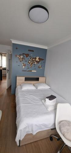 a bedroom with a large bed with a map on the wall at Sublime 3 Rooms Showers in Colombes