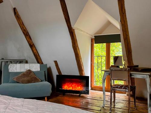 a living room with a couch and a fireplace at Domaine le Manoir, gîtes de charme et de caractère avec piscines privatisées et spa nordique in Fossemagne