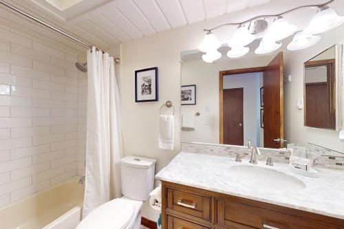 a bathroom with a sink and a toilet and a mirror at SunRiver E102 in Avon