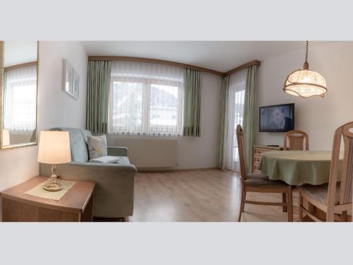 a living room with a couch and a table at das Alpenblick & Outdoor Lodge Nauders in Nauders