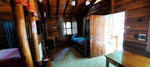 a room with a couch in a wooden cabin at BienAltura in Uspallata