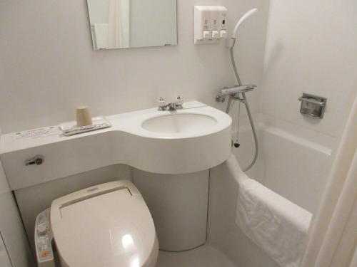 a small bathroom with a toilet and a sink at Osaka Fujiya Hotel in Osaka