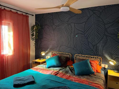 a bedroom with a bed with a black and white wall at Casa Zizi in Costa Calma